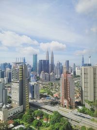 Aerial view of modern buildings in city against sky