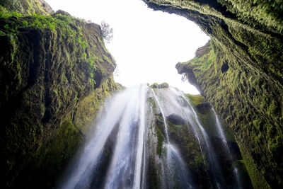 Scenic view of waterfall against sky