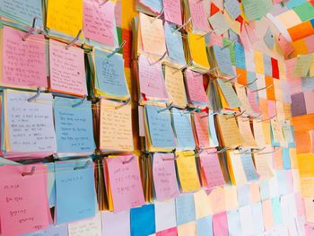 Colorful adhesive notes hanging on metal