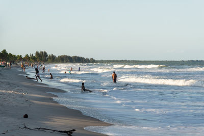 People walking on the sand of guaibim beach, in the city of valenca, bahia.