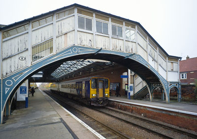 Footbridge at beverley station with diesel train to york at the platform