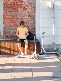 Man sits with laptop in street cafe. freelancer at work. student learns remotely from outdoors.