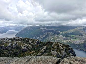 Scenic view of mountains against cloudy sky