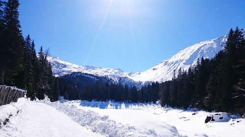 Snowcapped mountains against clear blue sky