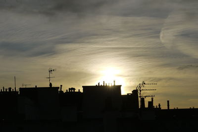 Silhouette city against sky during sunset