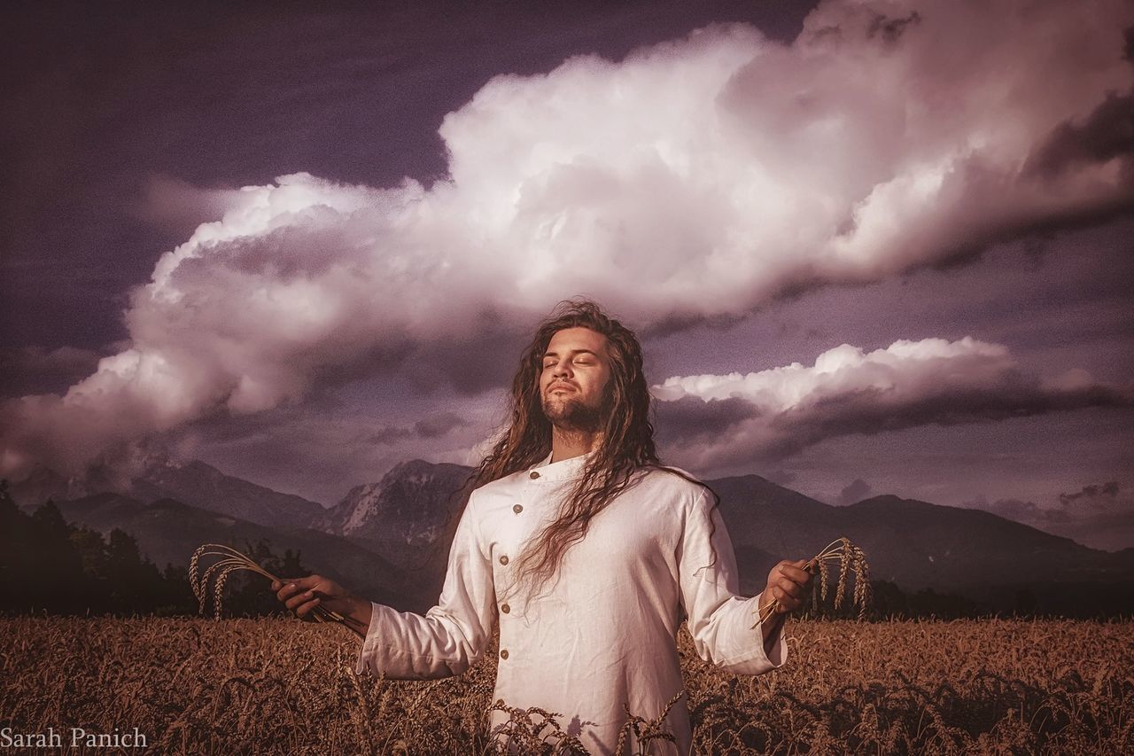 cloud - sky, sky, land, one person, lifestyles, real people, field, leisure activity, front view, young adult, nature, young women, scenics - nature, beauty in nature, casual clothing, mountain, environment, landscape, outdoors, hairstyle