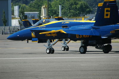 Side view of airplane on airport runway