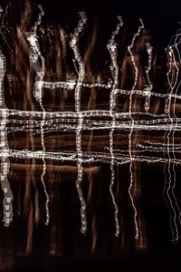 Close-up of icicles hanging against dark background