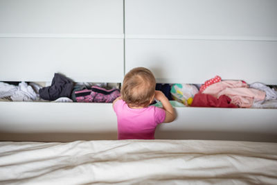 Boy sleeping on bed at home