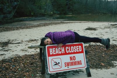 Rear view of woman lying down on land