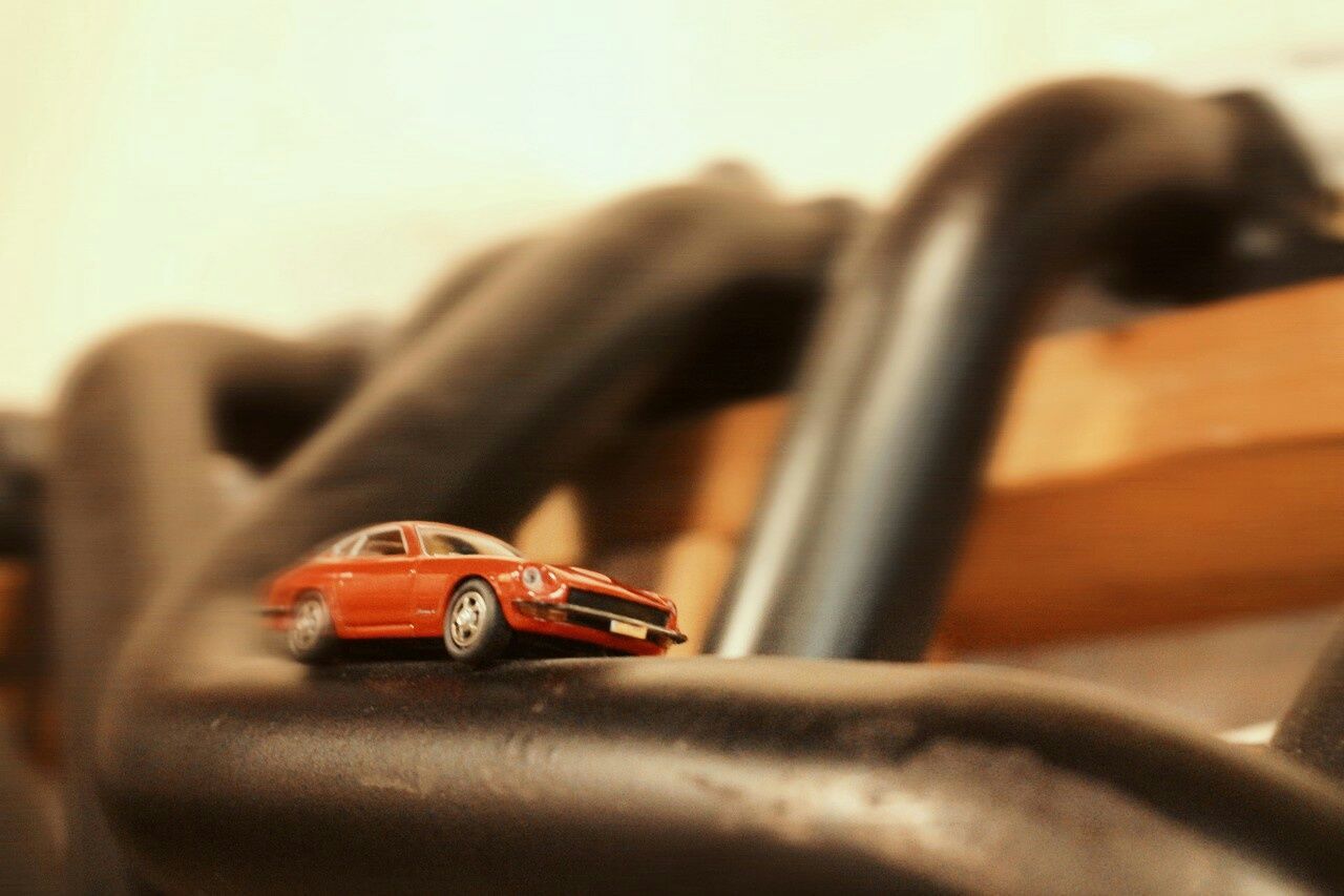 close-up, focus on foreground, selective focus, indoors, still life, part of, single object, no people, old-fashioned, cropped, metal, mode of transport, day, table, wood - material, car, transportation, detail, land vehicle, music