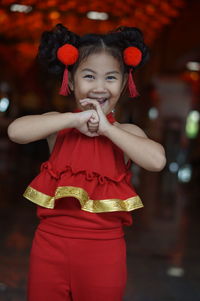 Portrait of cute girl with red mask