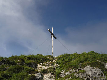 Low angle view of wind turbines against sky