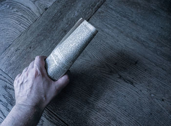 High angle view of person hand on metal wall