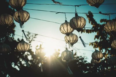 Low angle view of lanterns hanging against sky