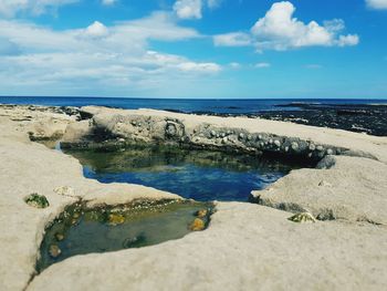 Scenic view of sea against blue sky