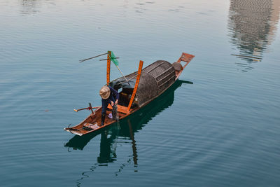 High angle view of man sitting in lake