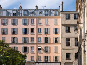 Low angle view of buildings against sky in paris