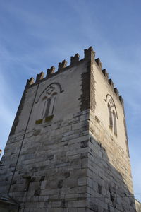 Low angle view of historic building against blue sky