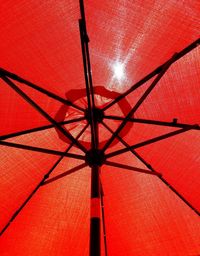 Low angle view of illuminated red umbrella