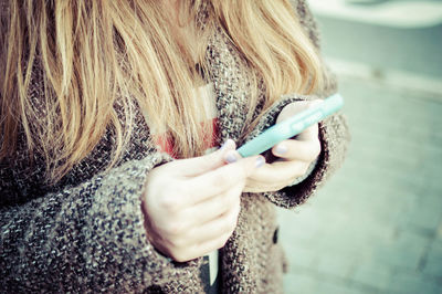 Midsection of woman using smart phone