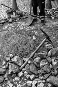 Low section of man working on rock