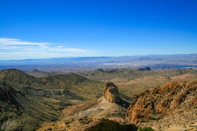 Scenic view of mountains against blue sky