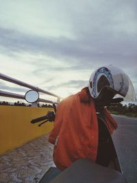 Man standing with umbrella against sky