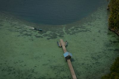 High angle view of people on sea shore, traditional jetty