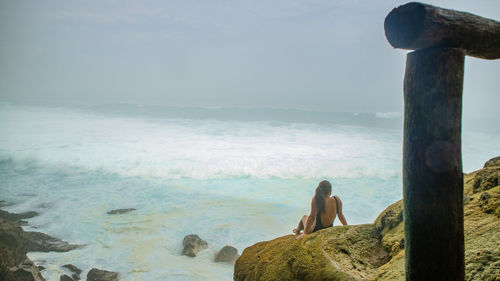 Man looking at sea against sky