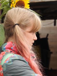 Side view of young woman with pigtails