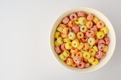 Directly above shot of fruits in bowl against white background