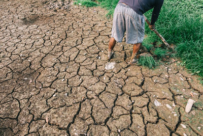 Low section of man working in mud