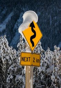 Road sign covered in snow.