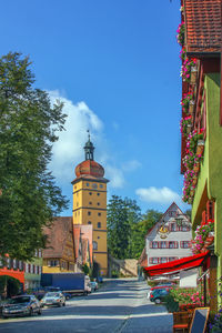 Street amidst buildings in city against sky