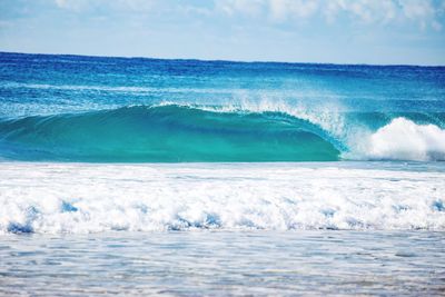 Scenic view of sea waves against sky