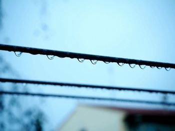 Low angle view of raindrops on blue sky