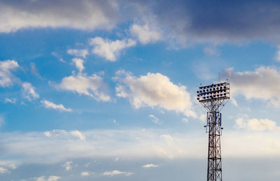 Stadium spotlight set on background of blue sky. cumulonimbus.