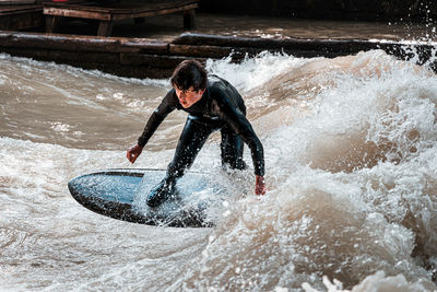 Full length of man splashing water