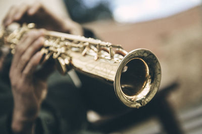 Close-up of person playing saxophone