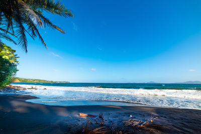 Scenic view of sea against blue sky