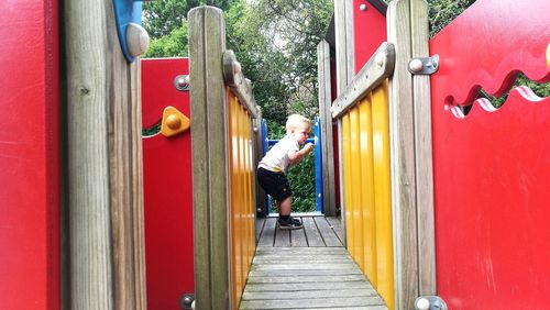 Man standing by red door