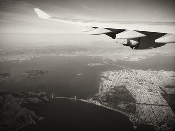 Cropped image of airplane flying over landscape