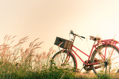 Bicycle on field against clear sky