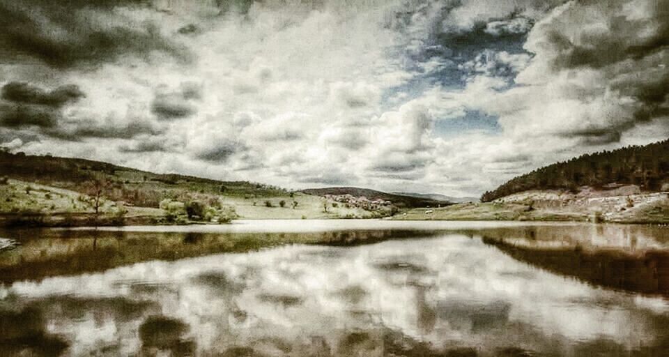 water, lake, tranquil scene, sky, tranquility, scenics, cloud - sky, reflection, beauty in nature, mountain, cloudy, nature, waterfront, cloud, landscape, river, idyllic, mountain range, non-urban scene, calm