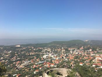 Aerial view of cityscape against clear sky