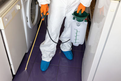 Low section of man cleaning floor