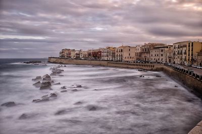 Scenic view of beach against sky in city