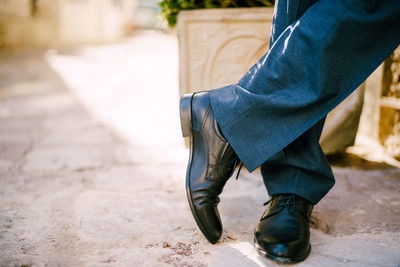 Low section of man standing outdoors