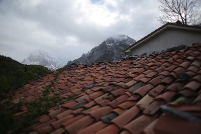 Houses on mountain against sky